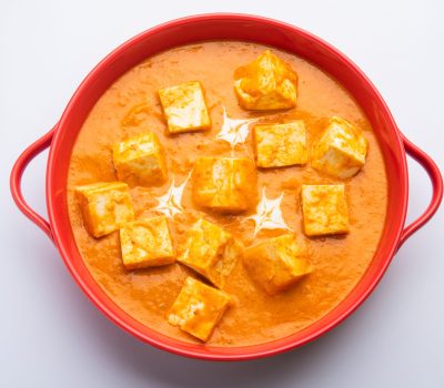 Paneer Butter Masala or Cheese Cottage Curry served with rice and laccha paratha